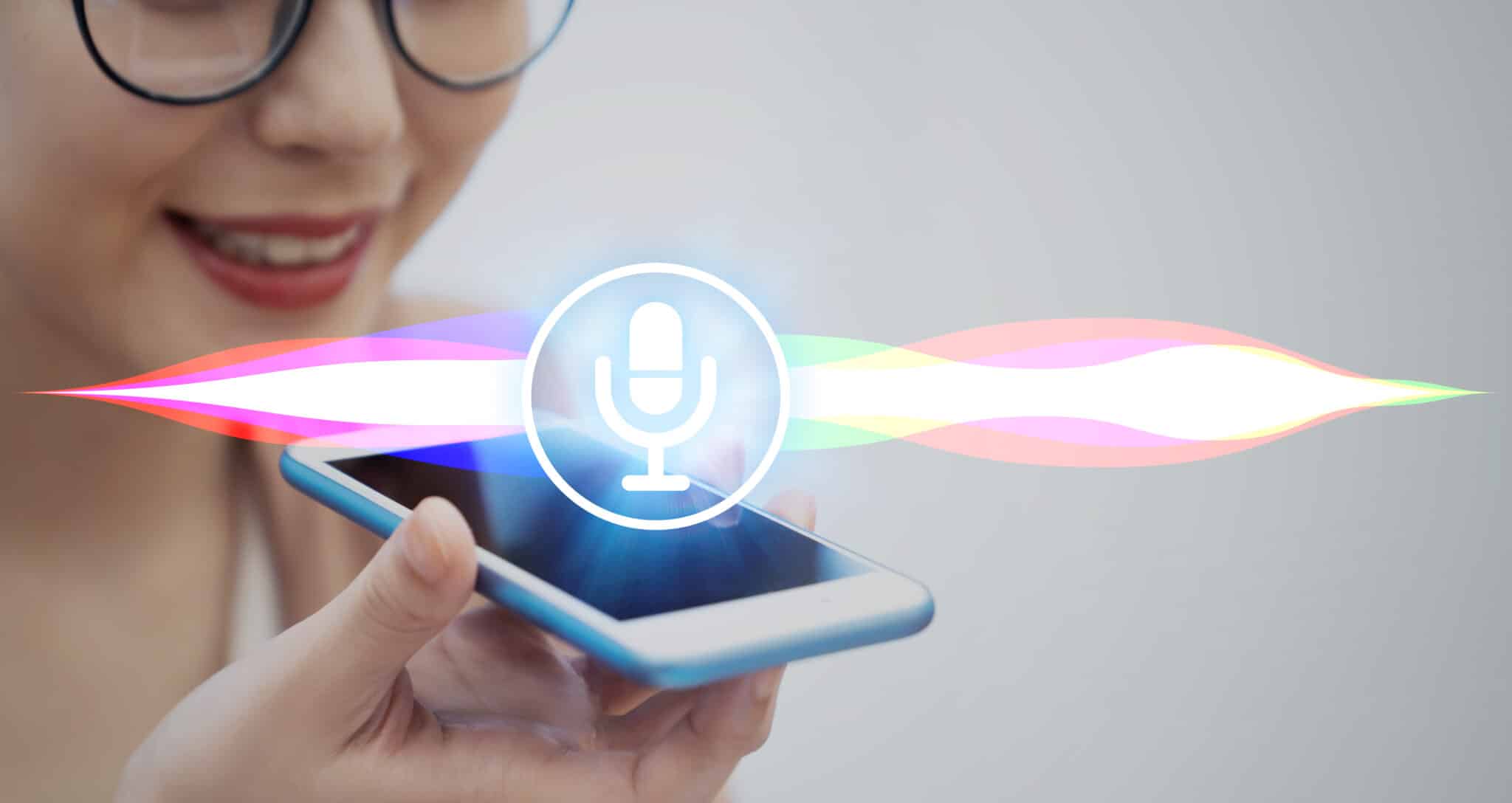 A woman speaking into a phone, using speech AI and voice recognition