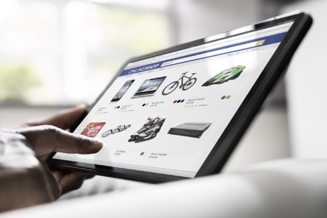 Close-up of a hand browsing an online shopping site on a tablet